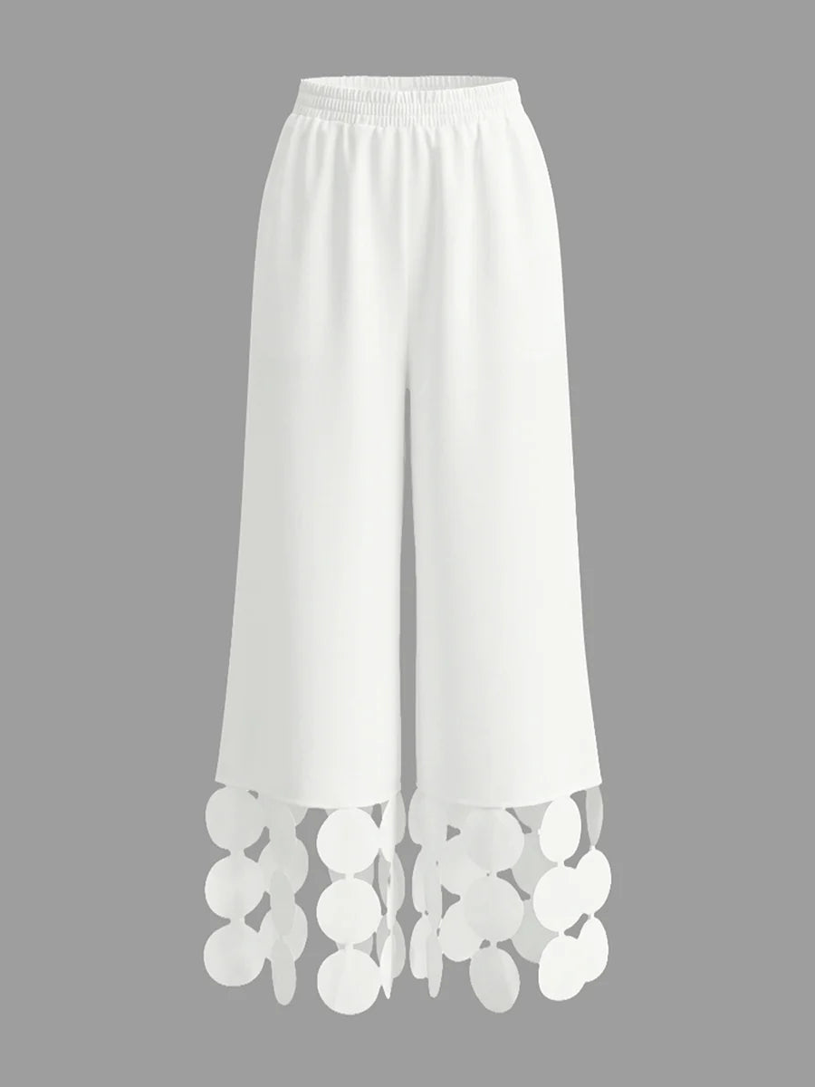 Pantalones pernera ancha con borlas color sólido