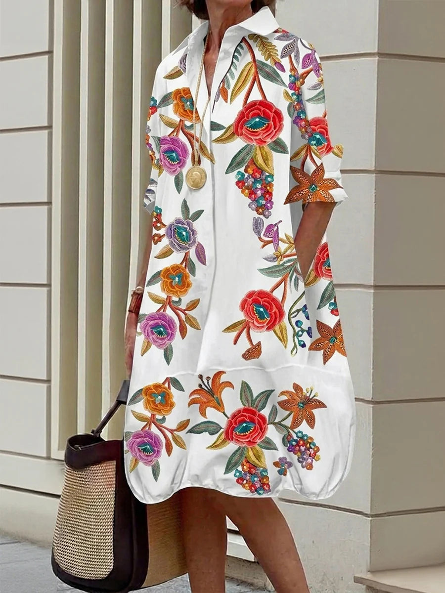 VESTIDO MIDI CAMISEIRO EM CORTE EM A DE MANGA MÉDIA COM BOTÕES, ESTAMPADO FLORAL EM CONTRASTE E BOLSOS