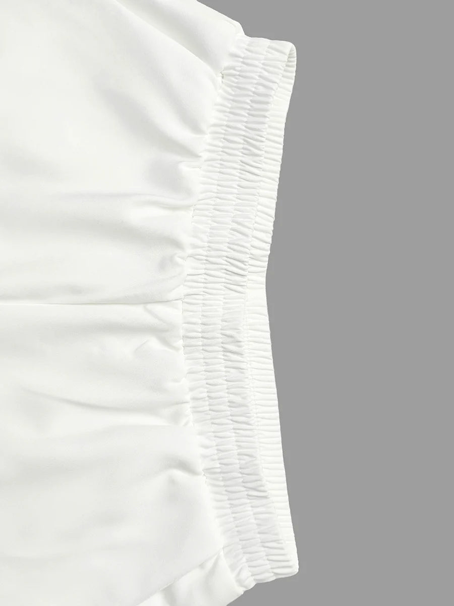 Pantalones pernera ancha con borlas color sólido