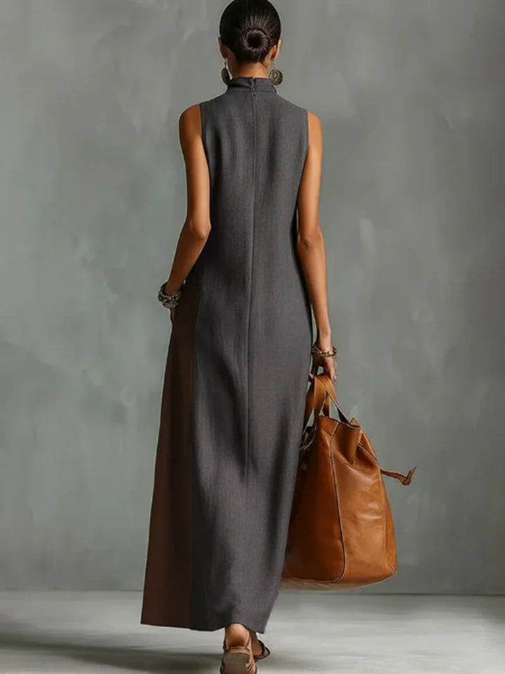VESTIDO MAXI ASSIMÉTRICO SEM MANGAS FOLGADO COM BOLSOS, COR EM CONTRASTE E GOLA ALTA