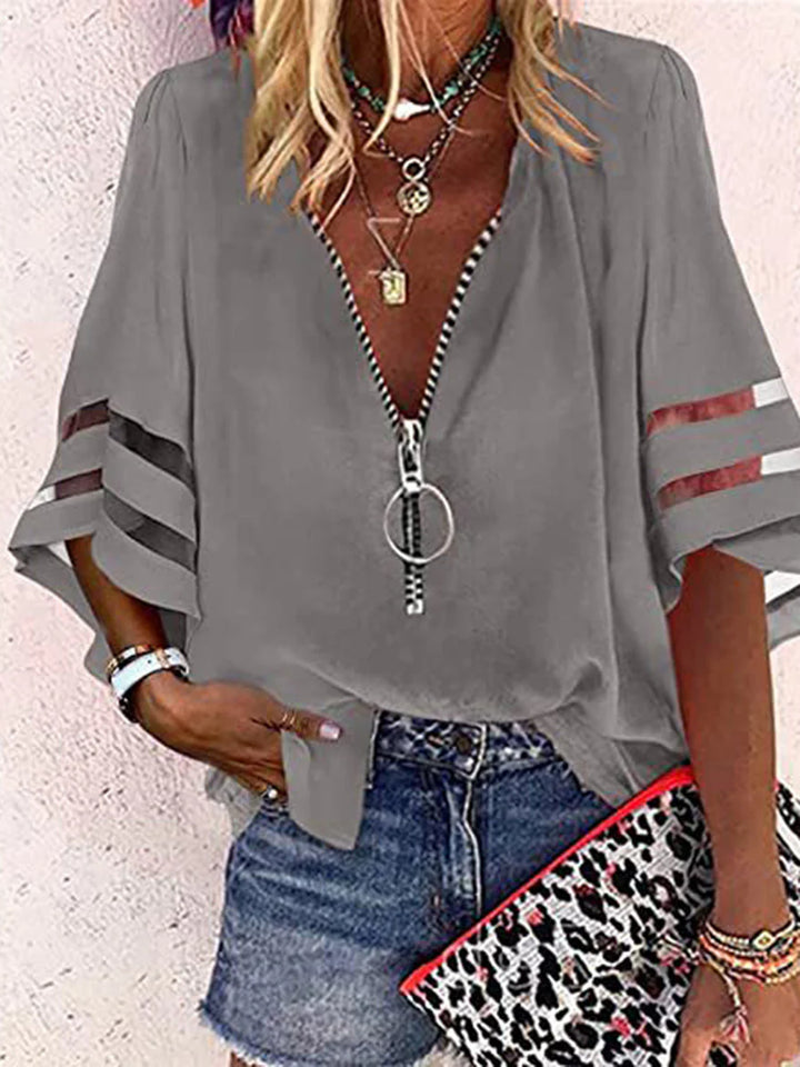 BLUSA FOLGADA DE MANGA TRÊS QUARTOS COM BAINHA, FECHO E GOLA MANDARIM