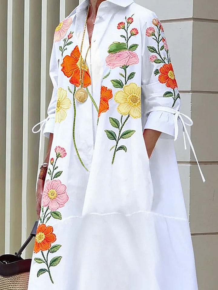 VESTIDO MIDI DE CAMISEIRO CORTE EM A DE MANGA MÉDIA COM BOTÕES, ESTAMPADO FLORAL, BOLSOS E LAÇO