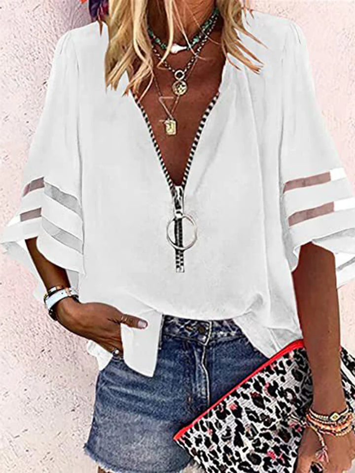 BLUSA FOLGADA DE MANGA TRÊS QUARTOS COM BAINHA, FECHO E GOLA MANDARIM